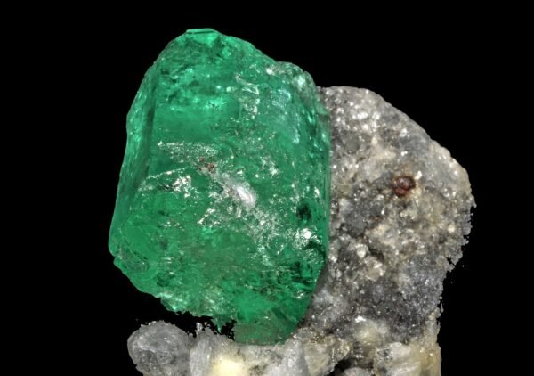 Natural rough emerald crystal on host rock