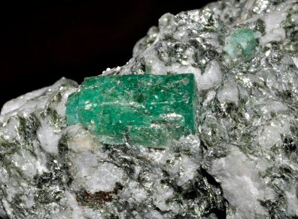 Rough emerald crystal with visible natural inclusions