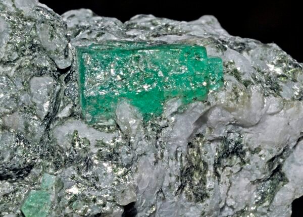 Hexagonal rough emerald crystal on host rock