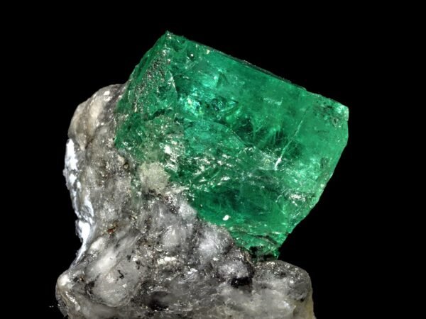 Rough emerald crystal with natural surface texture